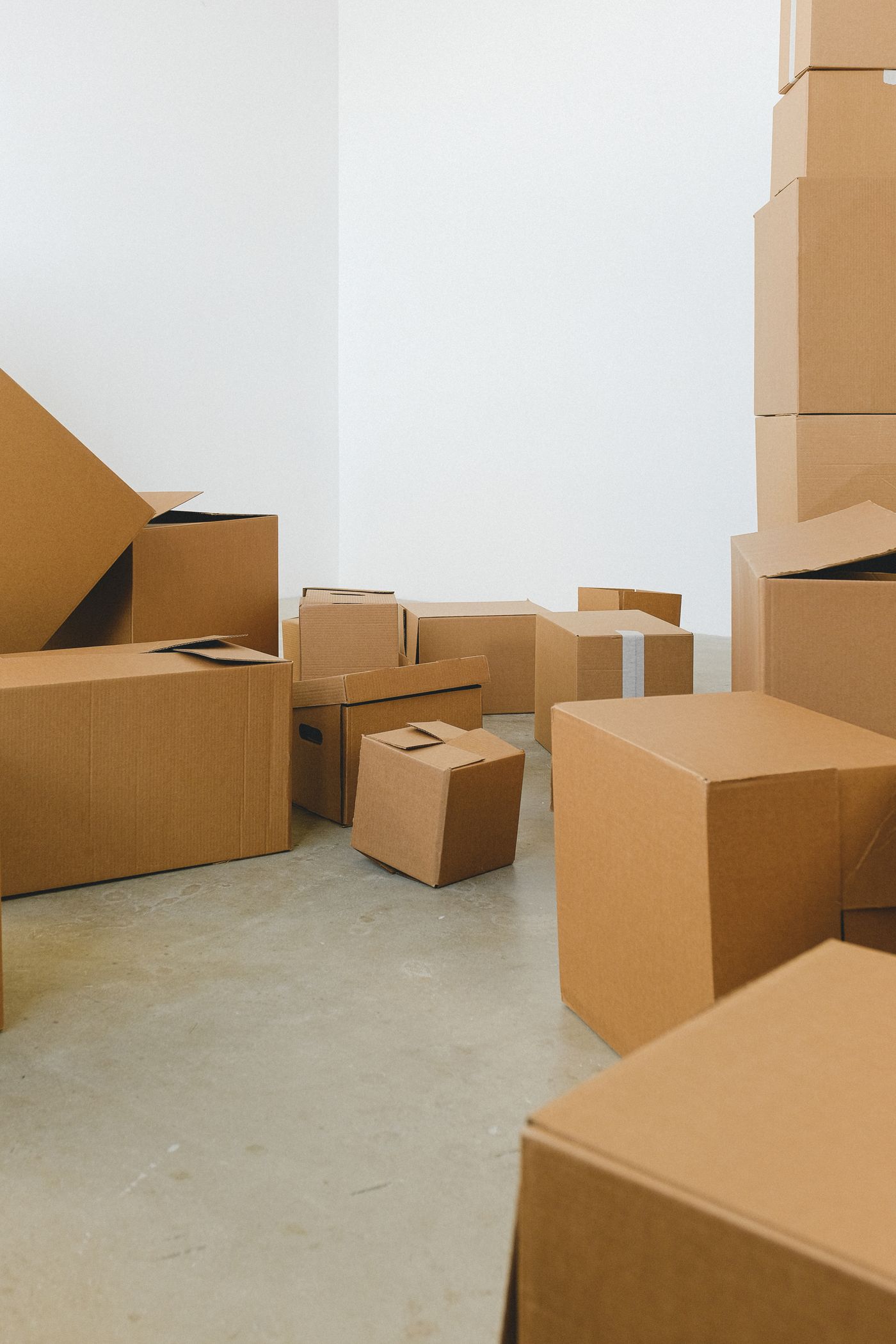 Labeled cartons staged for storage in a new house
