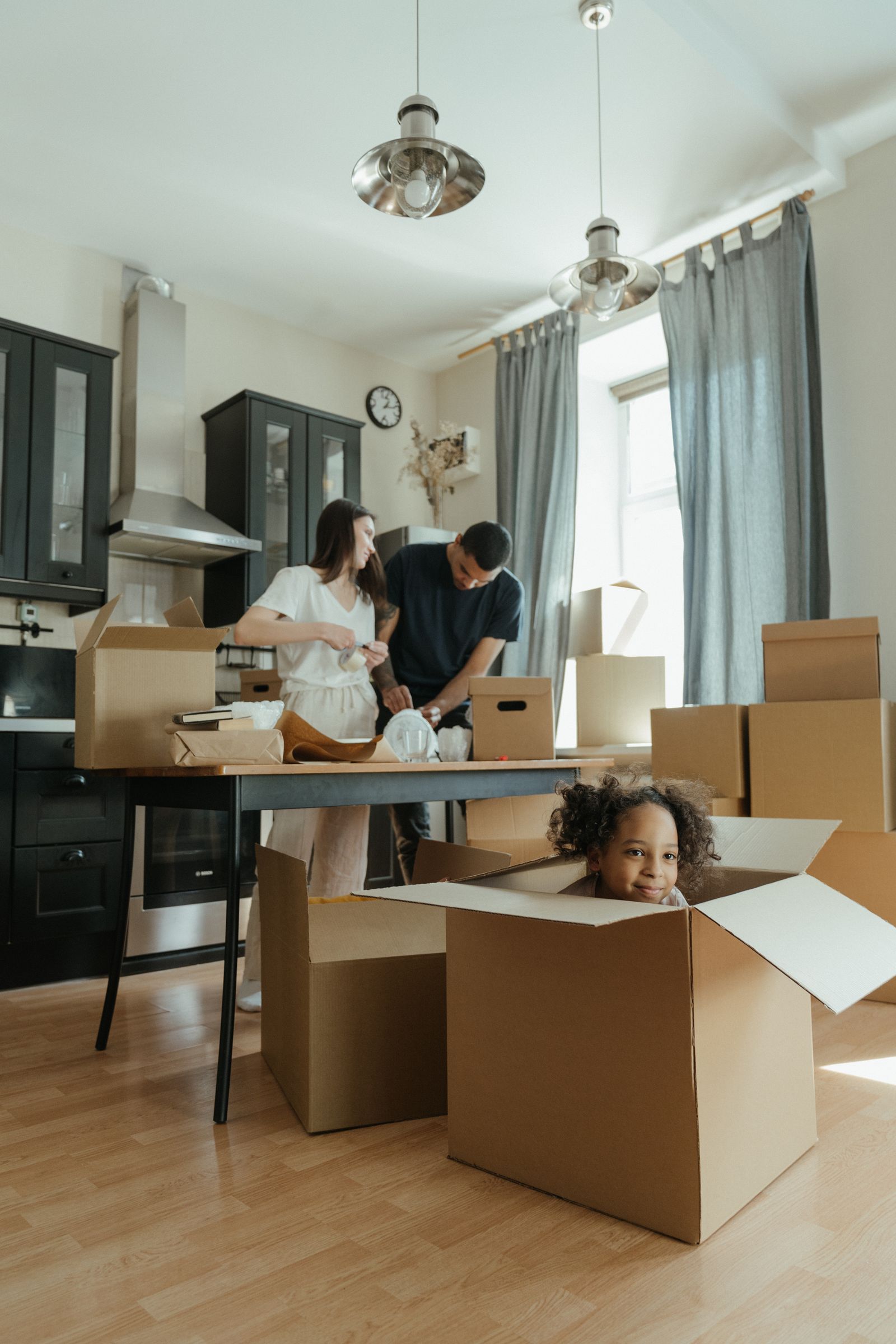 A couple packing boxes for an international move